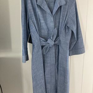 Fitted in waist, slightly flared at bottom and front button down and hidden